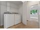 Laundry room featuring a washer, dryer, and access to the main bedroom at 5044 Wise Bird Dr, Windermere, FL 34786