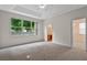 Spacious main bedroom with tray ceiling, large window, carpet, and ensuite bathroom at 5044 Wise Bird Dr, Windermere, FL 34786