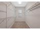 Walk-in closet with built-in shelving and a window for natural light at 5044 Wise Bird Dr, Windermere, FL 34786