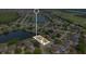 A beautiful home is captured from above, located in a peaceful lakeside community, surrounded by lush greenery at 5051 Silver Thistle Ln, St Cloud, FL 34772