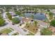 An elevated view of a vibrant neighborhood with homes featuring solar panels, surrounding a picturesque lake at 5051 Silver Thistle Ln, St Cloud, FL 34772