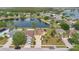 Aerial view showcasing a charming home with well-manicured lawn, nestled in a desirable neighborhood by the lake at 5051 Silver Thistle Ln, St Cloud, FL 34772