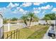 A well-maintained backyard with white picket fence and view of a lake provides a serene outdoor space at 5051 Silver Thistle Ln, St Cloud, FL 34772