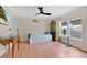 Bright and airy bedroom featuring a large window, a ceiling fan, and wood laminate flooring at 5051 Silver Thistle Ln, St Cloud, FL 34772
