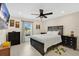 Bright bedroom with a ceiling fan, a window offering a nice view, and neutral walls at 5051 Silver Thistle Ln, St Cloud, FL 34772