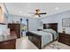 Comfortable bedroom featuring a ceiling fan, a window overlooking the water, and blue accent walls at 5051 Silver Thistle Ln, St Cloud, FL 34772