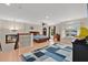 Large, open bedroom showcasing a decorative rug, ample natural light, and a view of the home's lower level at 5051 Silver Thistle Ln, St Cloud, FL 34772
