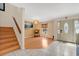 Bright foyer showcasing tile and wood flooring, an elegant chandelier, and staircase at 5051 Silver Thistle Ln, St Cloud, FL 34772