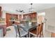 Well-lit kitchen with dark wood cabinets, granite countertops and a stainless steel refrigerator at 5051 Silver Thistle Ln, St Cloud, FL 34772