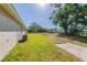 Large backyard with green grass and a mature shade tree at 5379 Botany Ct, Orlando, FL 32811