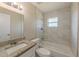 Bathroom featuring tiled walls, a granite vanity, and a tub with shower at 5379 Botany Ct, Orlando, FL 32811