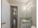Bathroom featuring tiled walls, vanity with a granite countertop, and doorway at 5379 Botany Ct, Orlando, FL 32811