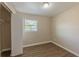 Cozy bedroom featuring laminate floors, neutral walls, a window, and closet at 5379 Botany Ct, Orlando, FL 32811