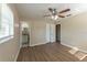 Bedroom with laminate floors, neutral walls, ceiling fan, and attached bath at 5379 Botany Ct, Orlando, FL 32811