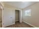 Bedroom features laminate floors, neutral walls, a window, closet, and doorway at 5379 Botany Ct, Orlando, FL 32811