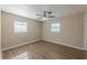 Bedroom featuring laminate floors, neutral walls, ceiling fan and two windows at 5379 Botany Ct, Orlando, FL 32811