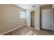 Bedroom featuring laminate floors, neutral walls, a window, and closet at 5379 Botany Ct, Orlando, FL 32811