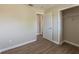Bedroom featuring laminate floors, neutral walls, a window, closet, and doorway at 5379 Botany Ct, Orlando, FL 32811