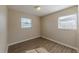 Bedroom with laminate floors, neutral walls, and two windows at 5379 Botany Ct, Orlando, FL 32811