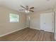 Bedroom featuring laminate floors, neutral walls, ceiling fan and closet at 5379 Botany Ct, Orlando, FL 32811