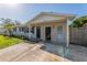 The facade of a cozy single-story home with dual entry doors, concrete pad, and well-kept yard at 5379 Botany Ct, Orlando, FL 32811