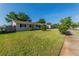 Cozy single-story home with lush green lawn, sidewalk, and mature trees at 5379 Botany Ct, Orlando, FL 32811
