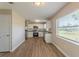 Bright kitchen features white cabinets, stainless steel appliances, and wood-look flooring at 5379 Botany Ct, Orlando, FL 32811