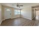 Bright living room featuring hard-surface floors, ceiling fan, and natural light from the window at 5379 Botany Ct, Orlando, FL 32811