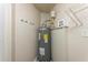 Water heater in utility closet with overhead shelving at 5379 Botany Ct, Orlando, FL 32811