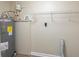 The utility room contains the water heater and some shelving at 5379 Botany Ct, Orlando, FL 32811