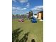 A large backyard with a playset at 5406 Crepe Myrtle Cir, Kissimmee, FL 34758