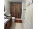 Bathroom with dark granite countertops and tile flooring at 5406 Crepe Myrtle Cir, Kissimmee, FL 34758