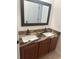 Bathroom featuring double sinks and dark hardware at 5406 Crepe Myrtle Cir, Kissimmee, FL 34758