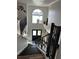 Inviting entryway with black double doors and staircase with iron railings at 5406 Crepe Myrtle Cir, Kissimmee, FL 34758