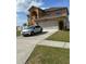 Charming two-story home with a spacious driveway and attached garage at 5406 Crepe Myrtle Cir, Kissimmee, FL 34758