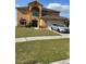 Lovely two-story home featuring a well-kept lawn, mature trees, and an attached two-car garage at 5406 Crepe Myrtle Cir, Kissimmee, FL 34758