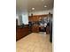 Well-equipped kitchen with brown cabinets, stainless steel appliances, and granite countertops at 5406 Crepe Myrtle Cir, Kissimmee, FL 34758