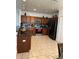 Well-equipped kitchen with brown cabinets, stainless steel appliances, and granite countertops at 5406 Crepe Myrtle Cir, Kissimmee, FL 34758