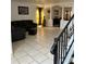 Open-concept living room with tiled flooring and comfortable seating and a dining area beyond at 5406 Crepe Myrtle Cir, Kissimmee, FL 34758
