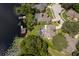 Aerial view highlighting a neighborhood on a lake with private docks, pools, and lush landscaping at 5479 Baytowne Pl, Oviedo, FL 32765