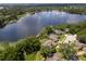 Wide aerial shot of lakefront homes showcasing private docks, serene water views, and mature tree coverage at 5479 Baytowne Pl, Oviedo, FL 32765