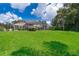 Spacious backyard features well-manicured lawn and screened-in patio for outdoor enjoyment at 5479 Baytowne Pl, Oviedo, FL 32765