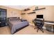 Comfortable bedroom with a bed, desk, and shelves, offering a cozy and functional space at 5479 Baytowne Pl, Oviedo, FL 32765