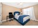 Cozy bedroom with blue accents, a desk and chair, and neutral colored walls and carpet at 5479 Baytowne Pl, Oviedo, FL 32765