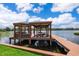 Private boat dock with boat lift and gazebo overlooking the serene lake at 5479 Baytowne Pl, Oviedo, FL 32765