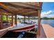 Covered boat lift and dock provide convenient access to the lake at 5479 Baytowne Pl, Oviedo, FL 32765