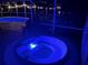 Relaxing hot tub and pool area illuminated at night, creating a spa-like experience at 5479 Baytowne Pl, Oviedo, FL 32765