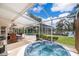 Relaxing hot tub with a view of a lush green lawn, lake and pool with an adjacent patio at 5479 Baytowne Pl, Oviedo, FL 32765