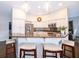 Kitchen with granite countertops, stainless steel appliances, white cabinetry, and a breakfast bar at 5479 Baytowne Pl, Oviedo, FL 32765