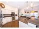 Open kitchen featuring granite countertops, stainless steel appliances, and white cabinets at 5479 Baytowne Pl, Oviedo, FL 32765